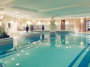 a swimming pool with a woman in the middle at Mercure Dartford Brands Hatch Hotel & Spa in Ash