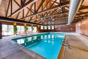 a large swimming pool in a building with a wooden ceiling at Cascade #54 in Durango