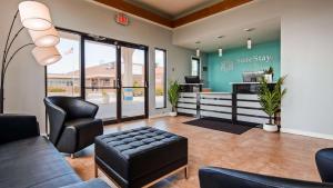 a waiting room with a couch and chairs at SureStay Hotel by Best Western Jacksonville South in Jacksonville