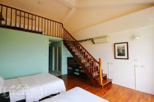 a room with a staircase and a bed in it at Vanilla Twilight in Wujie