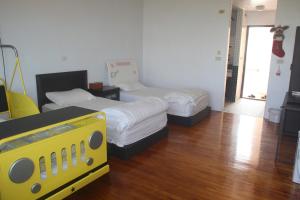 two beds in a room with wooden floors at Vanilla Twilight in Wujie