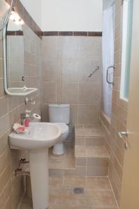 a bathroom with a sink and a toilet at Calm Sea House in Nea Fokea +21 photos