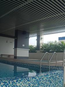 a swimming pool in a building next to a building at VUE RESIDENCES Jln Pahang, KL city - 2 ROOM in Kuala Lumpur