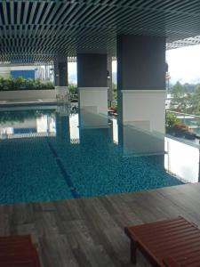 a large swimming pool in a building with a pool at VUE RESIDENCES SERVICE SUITE 8 Pax in Kuala Lumpur
