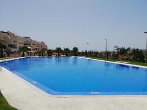 a large swimming pool with blue water at Paraíso el Toyo, vistas Cabo de Gata. Almeria in Almería