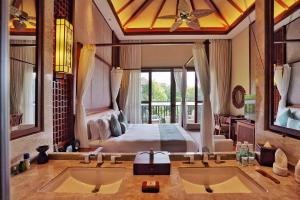 a master bathroom with two sinks and a bed at Sanya Ocean Sonic Banling Hotspring Resort in Sanya