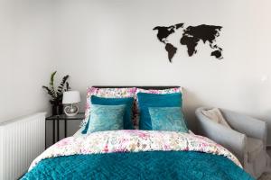 a bedroom with a bed with a world map on the wall at Luxury Apartment with Large Terrace in Wrocław