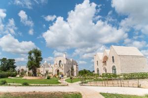 a view of a building with a blue sky and clouds at Ottolire Resort in Locorotondo +50 photos