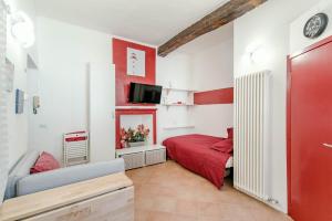 a small room with a red bed and a tv at Red Passion in Cernobbio