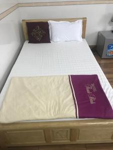 a bed with a wooden frame and a mattressvisor at Thanh Binh Hotel in Ha Tinh