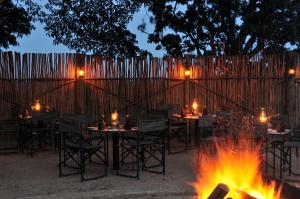 a group of tables and chairs around a fire pit at Premier Hotel The Winkler in White River