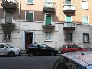 a group of cars parked in front of a building at Auri's House in Turin