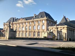 a large building with a fence in front of a street at gîte des Hortensias in Raon-aux-Bois