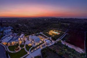 an aerial view of a mansion with a sunset at Ottolire Resort in Locorotondo