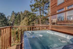 a hot tub on the deck of a house at Whale Song in Mendocino