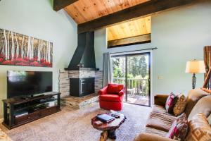 a living room with a couch and a fireplace at Nordic Retreat in Kings Beach