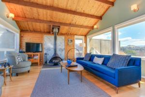 a living room with a blue couch and a fireplace at Ocean's Reach in Pacific City +17 photos