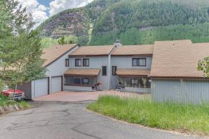 a house with a garage with a mountain in the background at Katsos Ranch Retreat in Vail