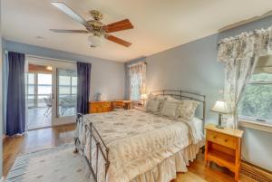 a bedroom with a bed and a ceiling fan at Home Away from Home + Studio in North Hero