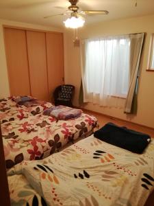 a bedroom with two beds and a window at Hakodate station 5minutes walk vacation stay in Hakodate