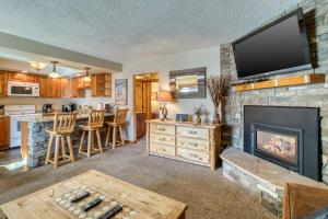 a living room with a fireplace and a flat screen tv at Main St. Condo in Breckenridge in Breckenridge