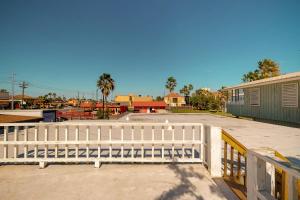 a white fence in front of a parking lot at The Kent House in South Padre Island