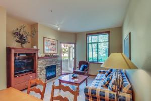 a living room with a couch and a fireplace at Powderhorn Lodge 107: Columbine Suite in Solitude