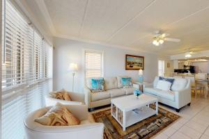 a living room with two couches and a table at Beachview Condominiums: #204 in South Padre Island