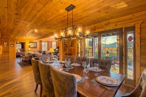 a dining room with a long table and chairs at Soaring Eagle in Sautee Nacoochee