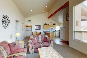 a living room with two couches and a kitchen at Rim Village O4 in Moab