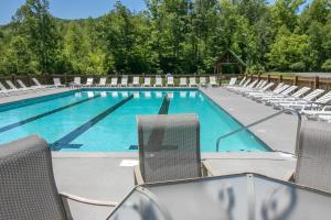 a large swimming pool with chairs and a swimming pool at Misty View Cabin in Hatchertown