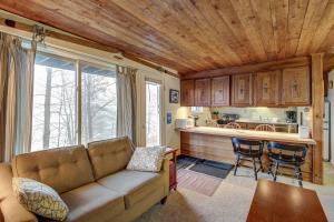 a living room with a couch and a kitchen at Okemo Trailside 08E in Ludlow