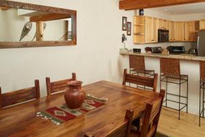 a kitchen and dining room with a wooden table and chairs at Saddle Ridge Townhome G-2 in Big Sky