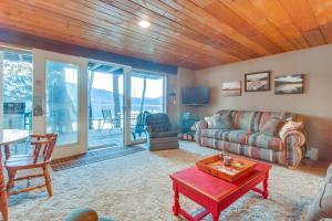 a living room with a couch and a table at Bay Point Lakefront 4A Down in Whitefish