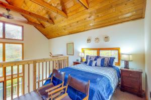 a bedroom with a bed and a balcony with windows at Bob's Bungalow in North Sherburne