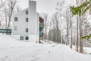 a house on a snow covered road with trees at Okemo Trailside 08E in Ludlow