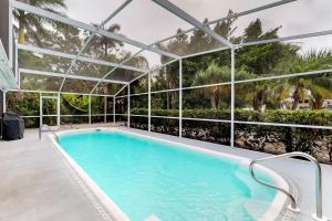 a swimming pool in a building with a glass enclosure at Coconut Tree in Anna Maria