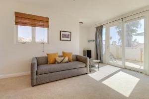 a living room with a couch and a window at Oceanside Sunset Shores in Oceanside