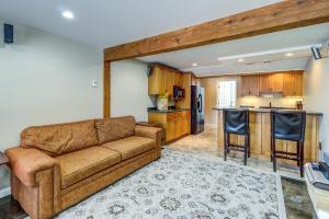 a living room with a couch and a kitchen at Alpine Drive Adventure in Telemark Village