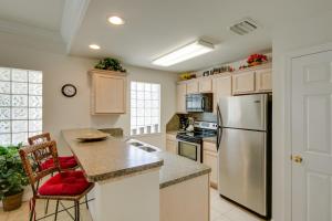a kitchen with a stainless steel refrigerator and a counter at Cloud Dancer Condos in South Padre Island