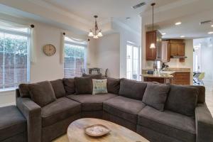a living room with a brown couch and a table at Oceanside Sunset Shores in Oceanside