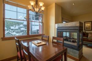 a dining room with a table and a fireplace at The Cache in West Village in Copper Mountain +14 photos