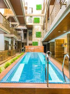 una gran piscina con azulejos azules en un edificio en The Piccolo Hotel of Boracay, en Boracay