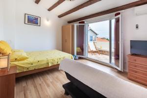 1 dormitorio con 1 cama, TV y ventana en Sea view suite Mateo, en Preko