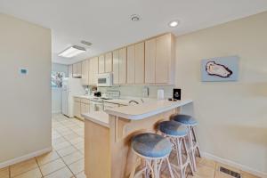 a kitchen with a counter and stools in it at Recovery Room in Indian Pass
