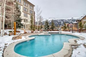 a swimming pool with snow on the ground at Passage Point 422 in Copper Mountain