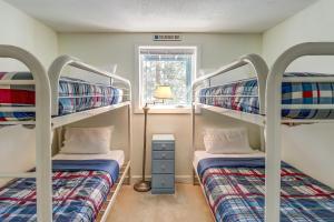 two bunk beds in a room with a window at Okemo Trailside 6A in Ludlow +29 photos