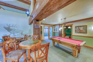 a living room with a pool table and chairs at Springs Lodge 8888 in Keystone