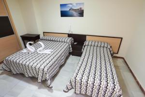 Postel nebo postele na pokoji v ubytování Hostal la Campana