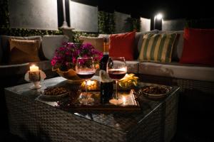 a living room with two glasses of wine on a table at luxury evergreen terrace in Soriano nel Cimino